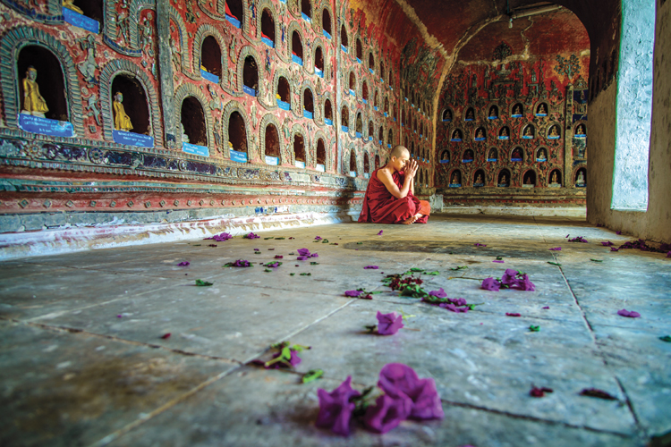 A monk in Myanmar exemplifies the peace of his faith.